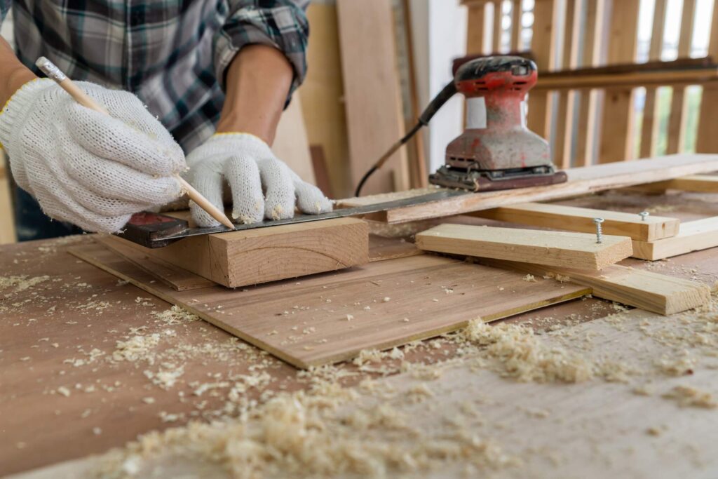 Man measuring wood for furniture